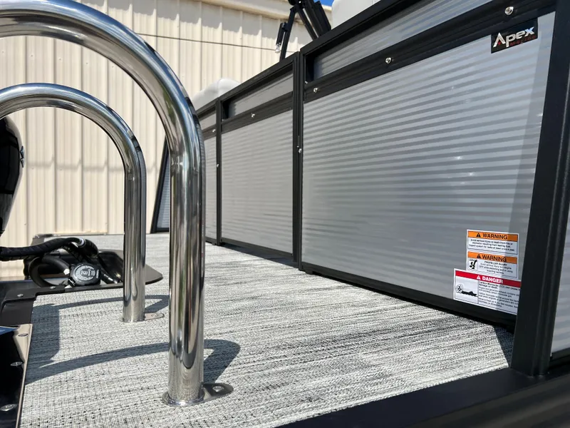 Slide: The Image of 2024 Qwest RLS 820 boat deck with stainless steel railings and Apex branding. - 4