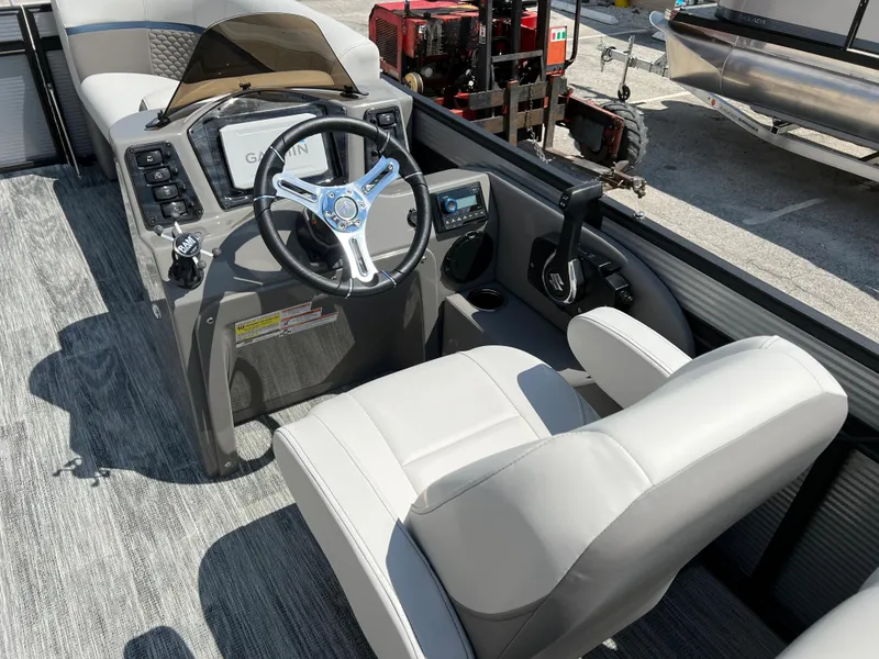 Slide: The Image of 2024 Qwest RLS 820 boat cockpit with steering wheel and captain's chair. - 6