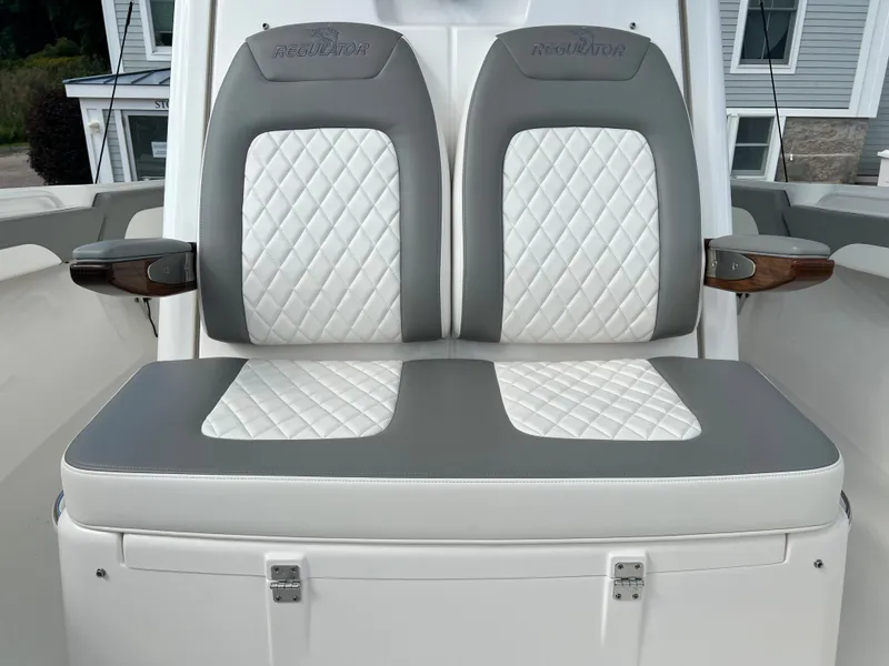 Slide: The Image of 2024 Regulator 31 boat with dual cushioned seats and diamond-stitched upholstery. - 10