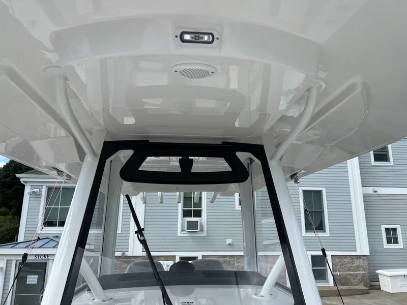 Slide: The Image of 2024 Regulator 31 boat's helm station with T-top and electronics. - 11