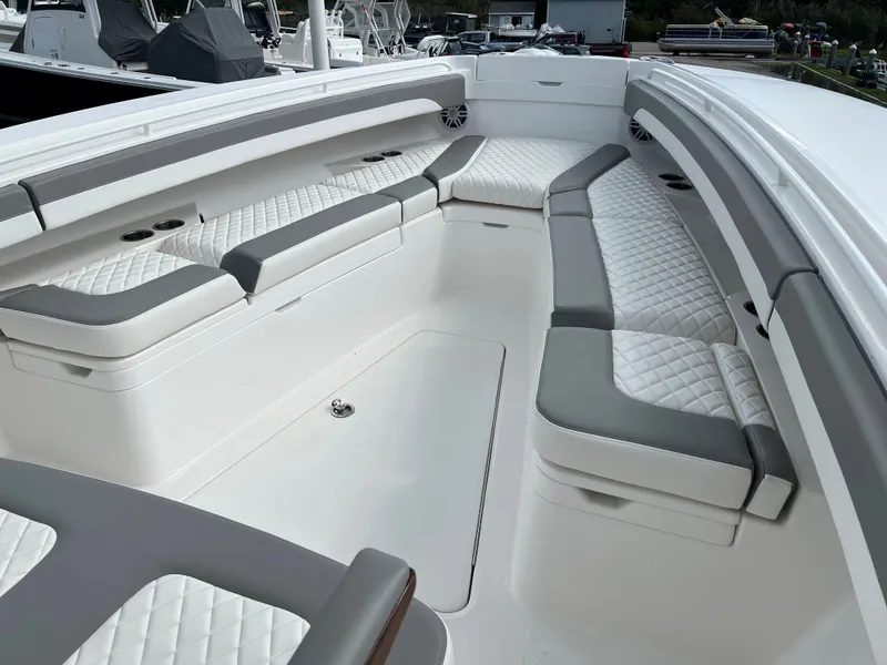 Slide: The Image of 2024 Regulator 31 boat with spacious, cushioned seating in white and gray. - 13