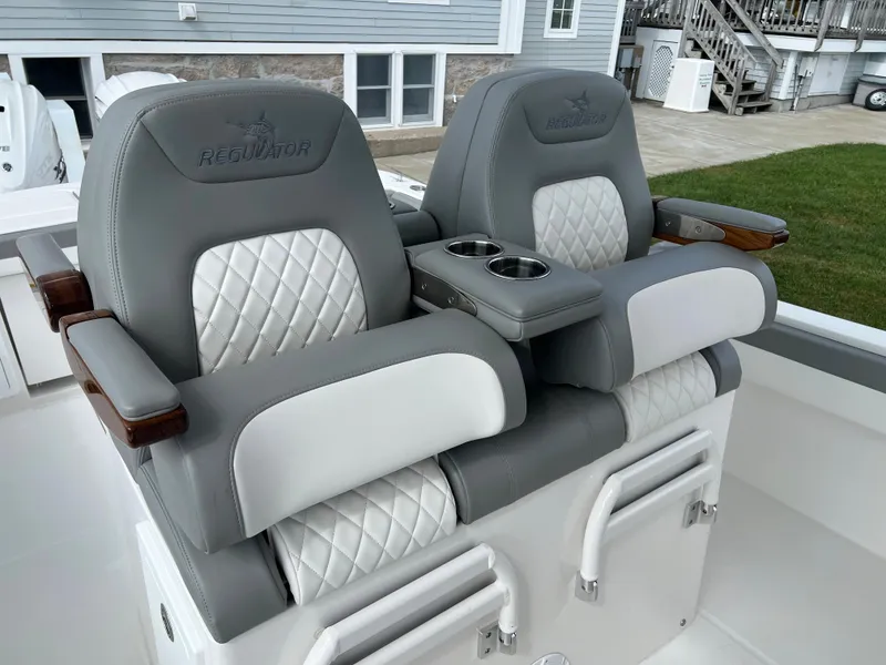 Slide: The Image of 2024 Regulator 31 boat with luxurious dual captain's chairs and cup holders. - 14
