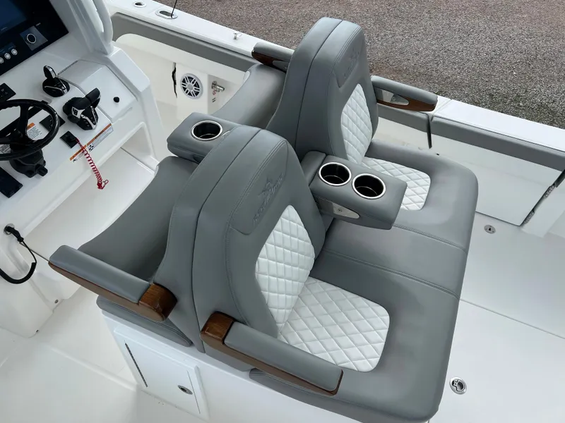 Slide: The Image of 2024 Regulator 31 boat with luxurious dual captain's chairs and cup holders. - 17