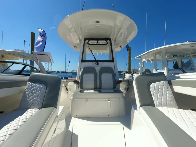 Slide: The Image of 2024 Regulator 31 boat interior with cushioned seating and helm station. - 22