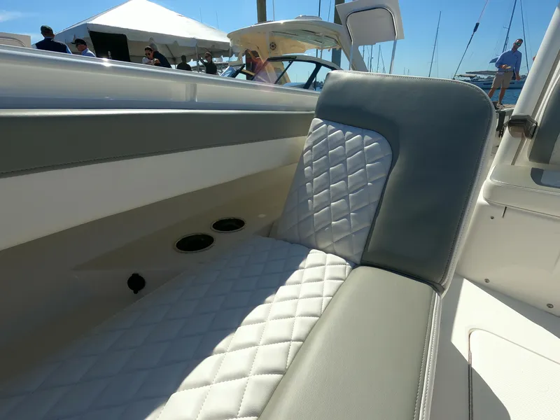 Slide: The Image of 2024 Regulator 31 boat interior with quilted seating and cup holders. - 23