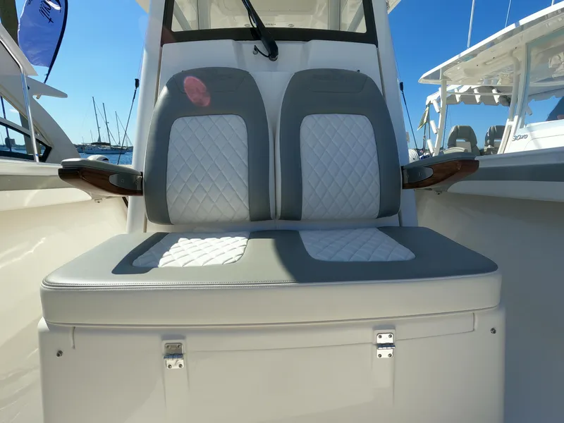 Slide: The Image of 2024 Regulator 31 boat with dual cushioned seats and storage compartment. - 24