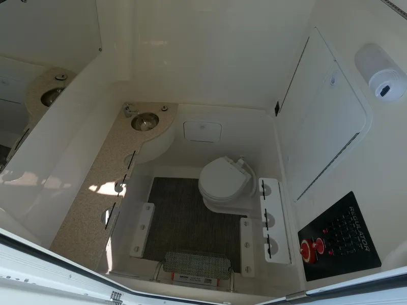 Slide: The Image of 2024 Regulator 31 boat interior bathroom with sink and toilet. - 27