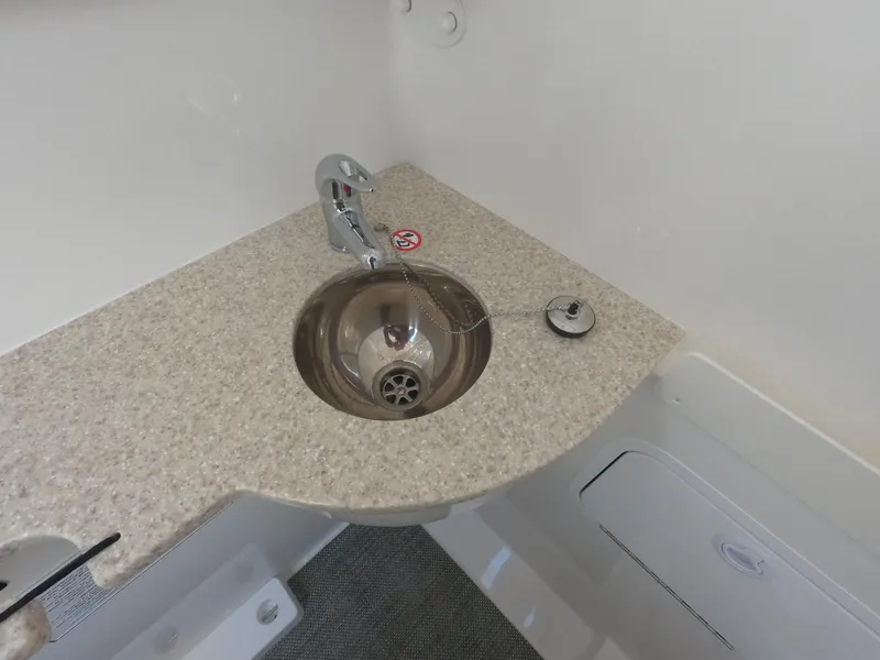 Slide: The Image of 2024 Regulator 31 boat interior sink with faucet and countertop. - 28