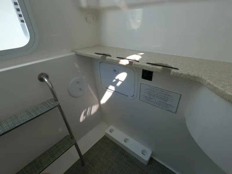 Slide: The Image of 2024 Regulator 31 boat interior with storage compartment and steps. - 29