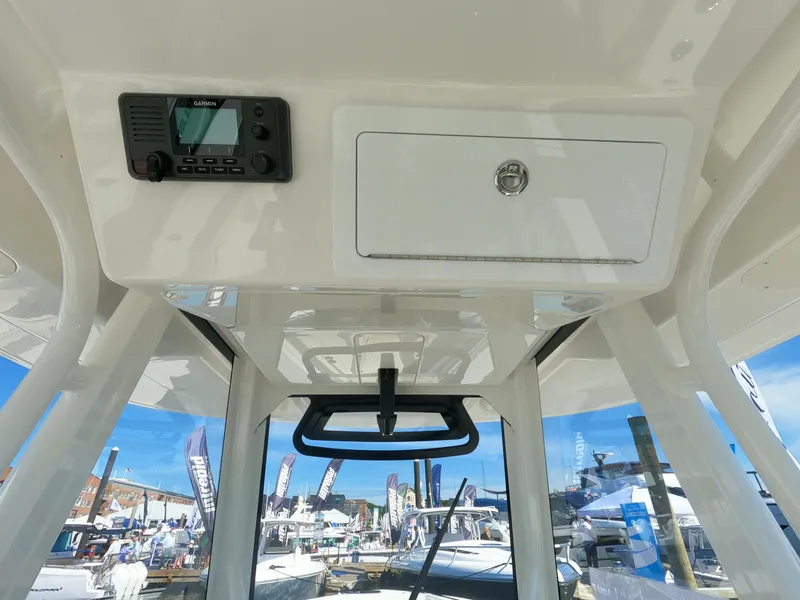 Slide: The Image of 2024 Regulator 31 boat console with electronic display at a marina. - 32