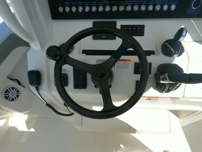 Slide: The Image of 2024 Regulator 31 boat helm with steering wheel and control panel. - 34
