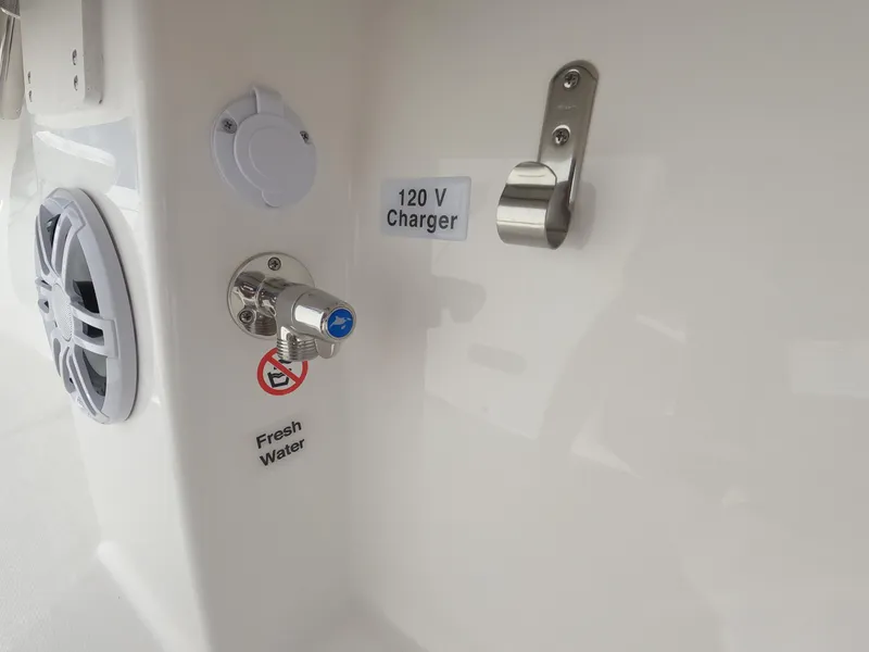 Slide: The Image of 2024 Regulator 31 boat with 120V charger and fresh water outlet. - 36