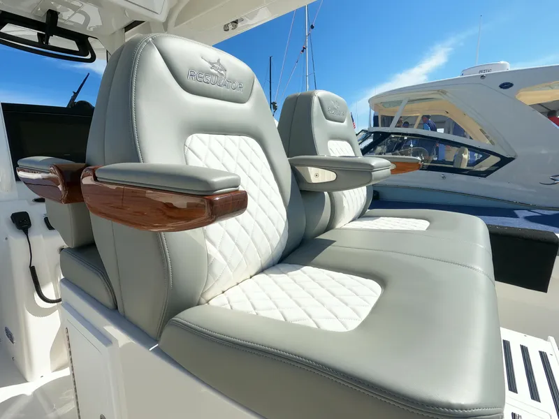 Slide: The Image of 2024 Regulator 31 boat with luxurious leather seating and wooden armrests. - 38