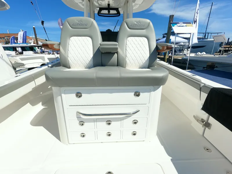 Slide: The Image of 2024 Regulator 31 boat interior with cushioned seats and storage drawers. - 39