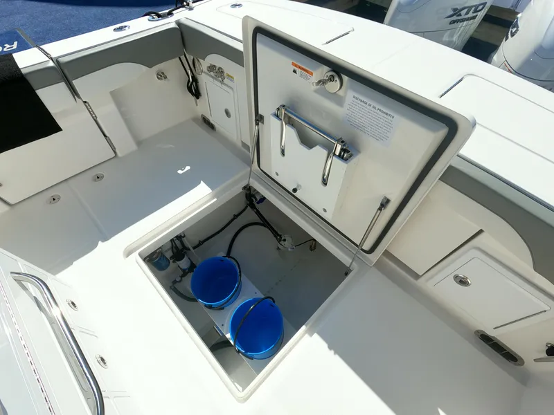 Slide: The Image of 2024 Regulator 31 boat with open storage compartment and blue buckets. - 40