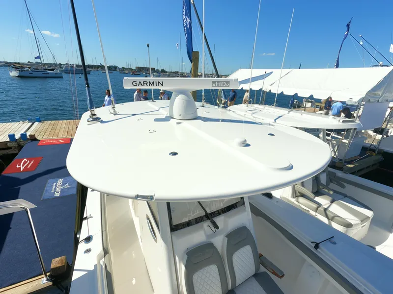 Slide: The Image of 2024 Regulator 31 boat docked at a marina, featuring Garmin radar. - 46