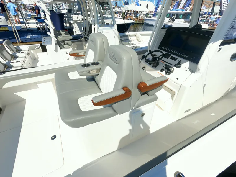 Slide: The Image of 2024 Regulator 31 boat interior with dual captain's chairs and advanced navigation system. - 49
