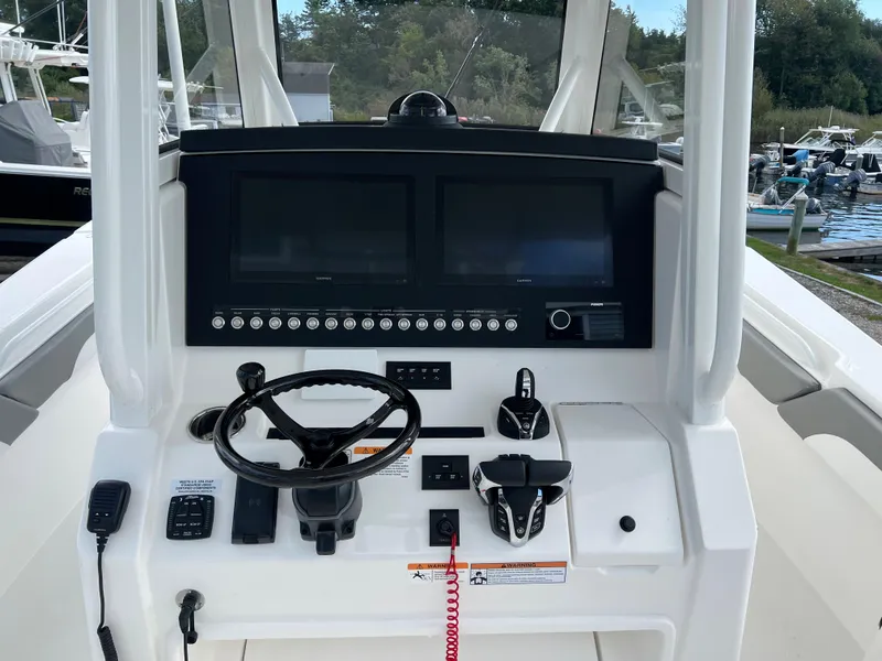 Slide: The Image of 2024 Regulator 31 boat dashboard with dual screens and controls. - 6