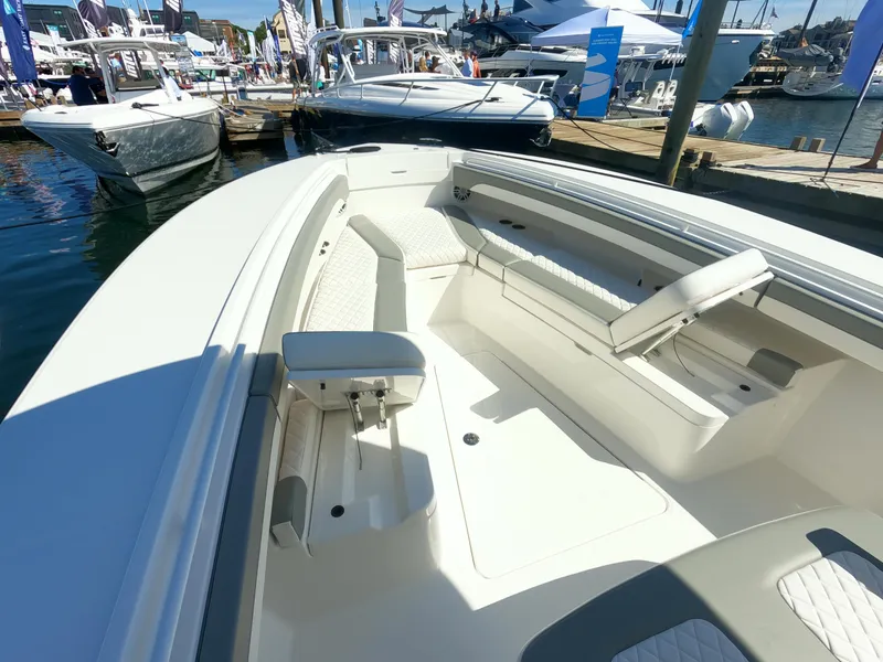 Slide: The Image of 2024 Regulator 31 boat interior at a marina, showcasing seating and deck layout. - 8