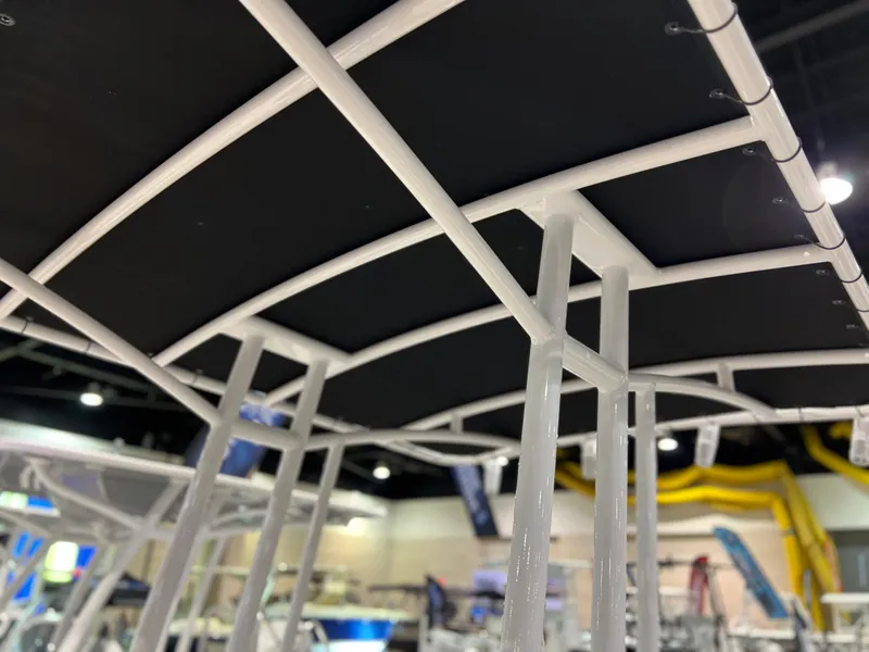 Slide: The Image of Close-up of Clearwater 2000 boat's canopy frame, 2024 model, at an indoor exhibition. - 11