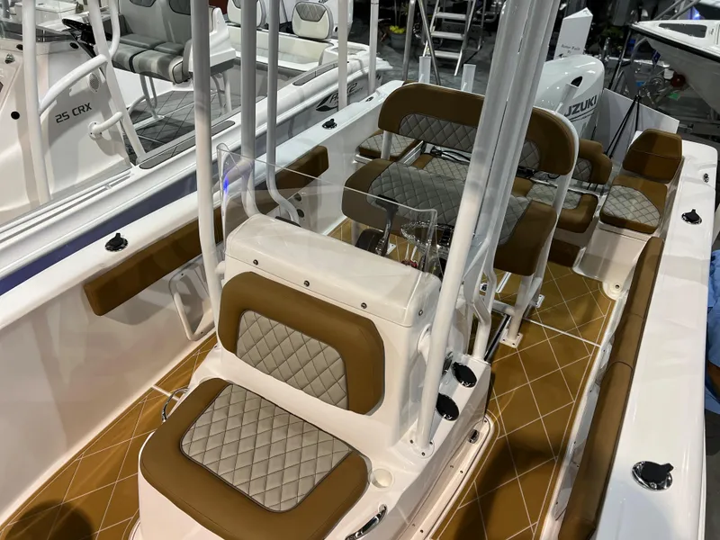 Slide: The Image of 2024 Clearwater 2000 boat interior with tan and white cushioned seating. - 12