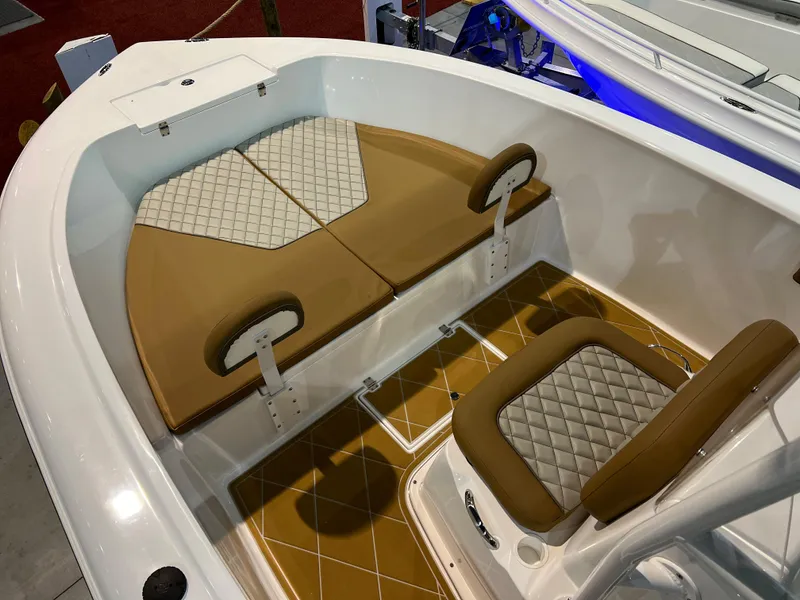 Slide: The Image of Clearwater 2000 boat interior, 2024 model, featuring tan and white cushioned seating. - 13