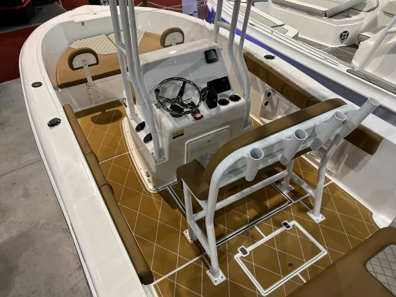 Slide: The Image of 2024 Clearwater 2000 boat interior with tan and white seating, center console, and rod holders. - 14