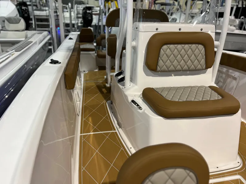 Slide: The Image of 2024 Clearwater 2000 boat interior with cushioned seating and diamond-stitched upholstery. - 15