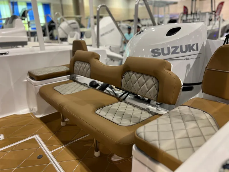 Slide: The Image of Clearwater 2000 boat interior with Suzuki engine, 2024 model, featuring brown and gray cushioned seating. - 3