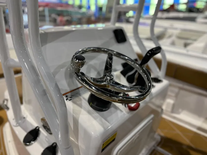 Slide: The Image of Clearwater 2000 boat steering console, 2024 model, featuring a chrome steering wheel and control panel. - 5