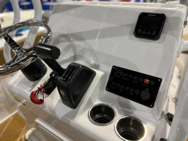 Slide: The Image of Clearwater 2000 boat console, 2024 model, featuring steering wheel, controls, and cup holders. - 8