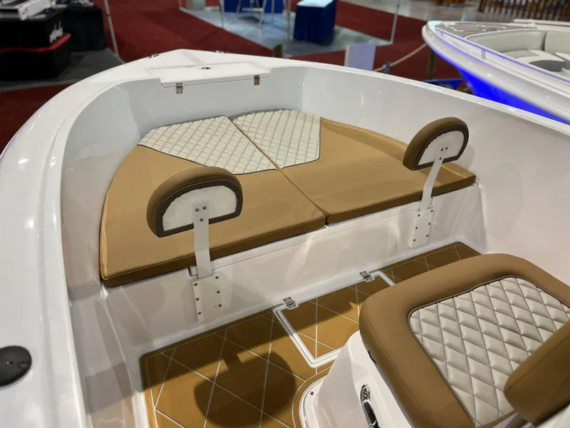 Slide: The Image of 2024 Clearwater 2000 boat interior with cushioned seating and diamond-stitched upholstery. - 9