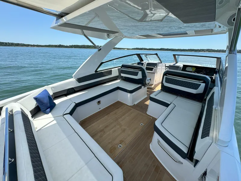 Slide: The Image of 2024 Cobalt R35 Outboard boat interior with spacious seating and scenic water view. - 10