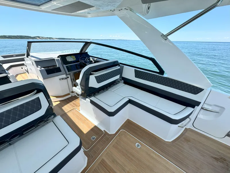 Slide: The Image of 2024 Cobalt R35 Outboard boat interior with luxurious seating and ocean view. - 11
