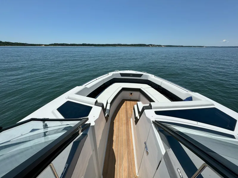 Slide: The Image of 2024 Cobalt R35 Outboard boat bow view on a calm lake. - 15
