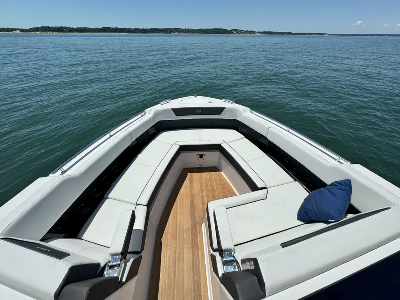 Slide: The Image of 2024 Cobalt R35 Outboard boat with spacious seating on calm water. - 16