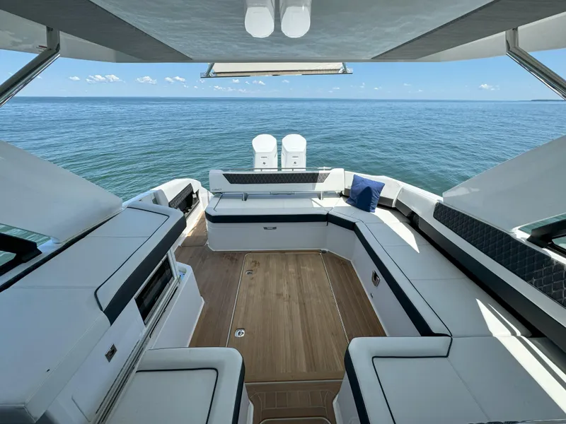 Slide: The Image of 2024 Cobalt R35 Outboard boat interior with ocean view, spacious seating, and modern design. - 18