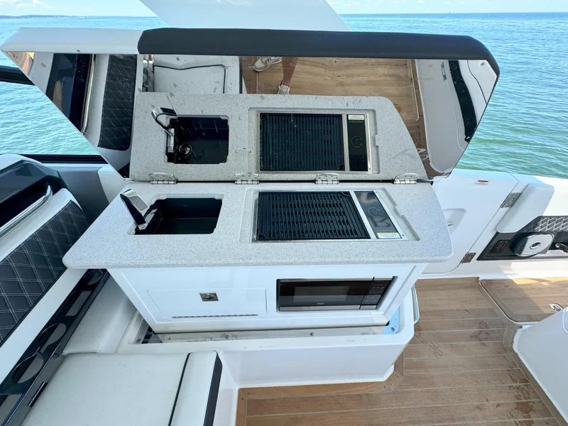 Slide: The Image of 2024 Cobalt R35 Outboard boat with open kitchenette and ocean view. - 20