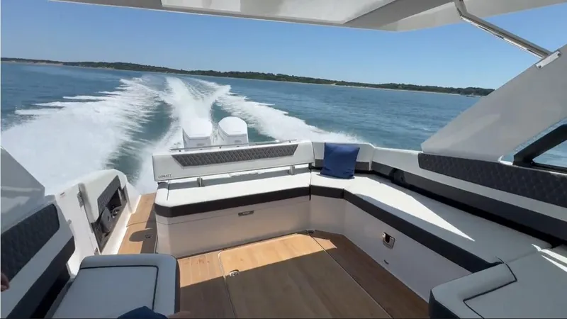 Slide: The Image of 2024 Cobalt R35 Outboard cruising on open water, featuring spacious seating and modern design. - 23