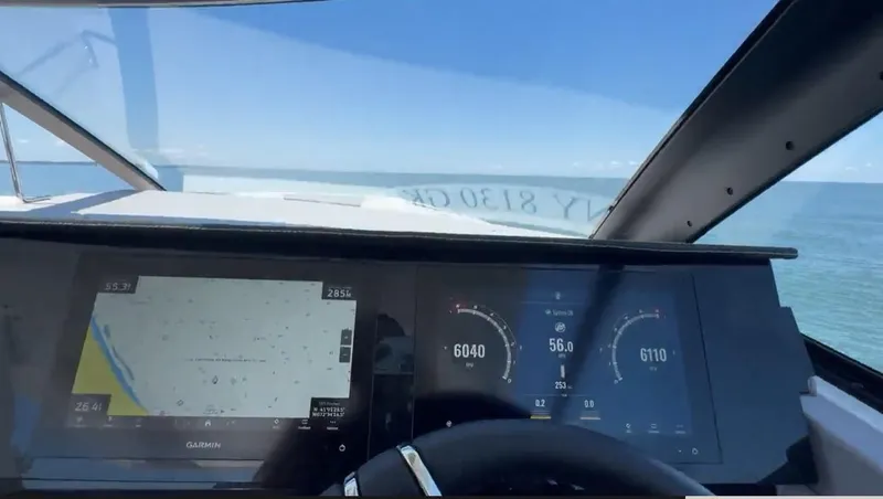 Slide: The Image of Dashboard view of 2024 Cobalt R35 Outboard boat with navigation and speed displays. - 24