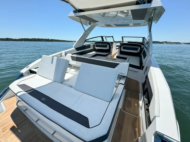 Slide: The Image of 2024 Cobalt R35 Outboard luxury boat with spacious seating on a serene lake. - 8
