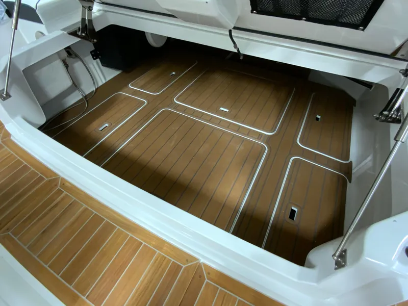 Slide: The Image of 2024 Cobalt R35 Outboard boat with teak flooring in the storage compartment. - 9