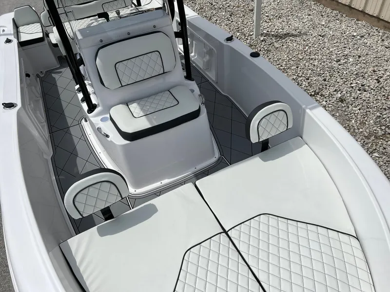 Slide: The Image of 2024 Clearwater 1900 boat interior with white cushioned seating and diamond stitching. - 10
