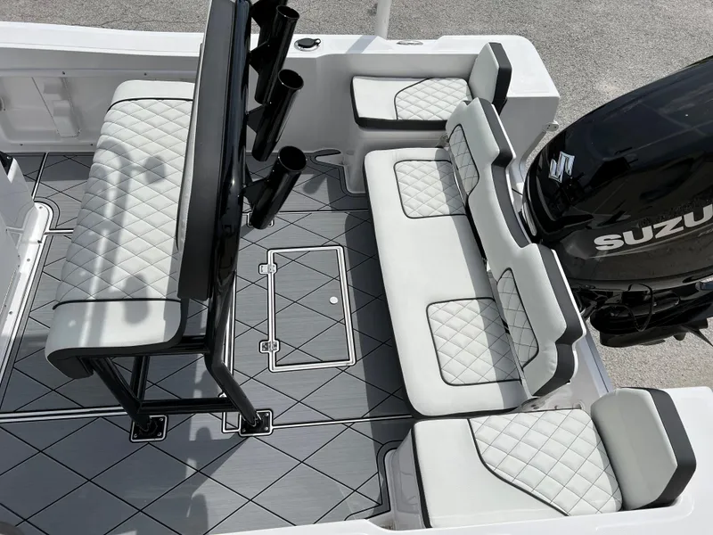 Slide: The Image of 2024 Clearwater 1900 boat interior with cushioned seating and Suzuki outboard motor. - 13