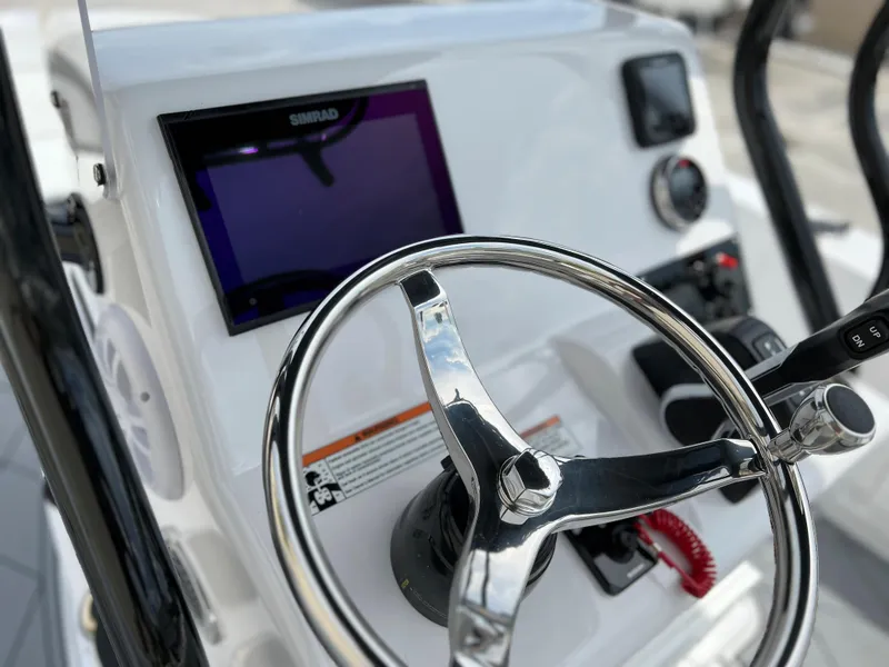 Slide: The Image of 2024 Clearwater 1900 boat dashboard with steering wheel and navigation screen. - 14