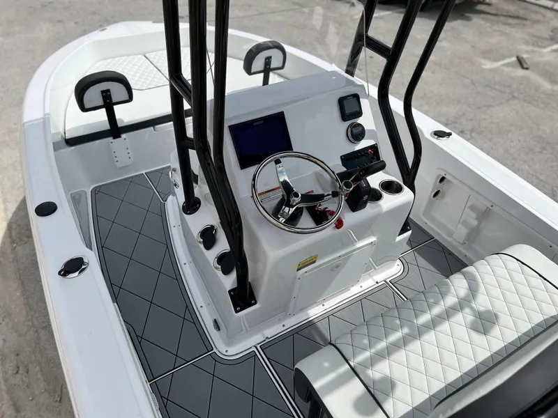 Slide: The Image of 2024 Clearwater 1900 boat interior with modern console and seating. - 15