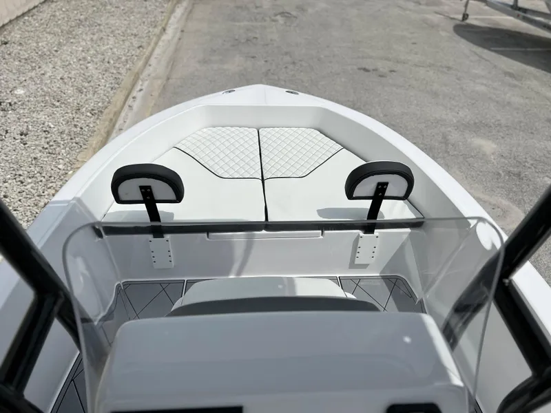 Slide: The Image of 2024 Clearwater 1900 boat interior with cushioned seating and console. - 16