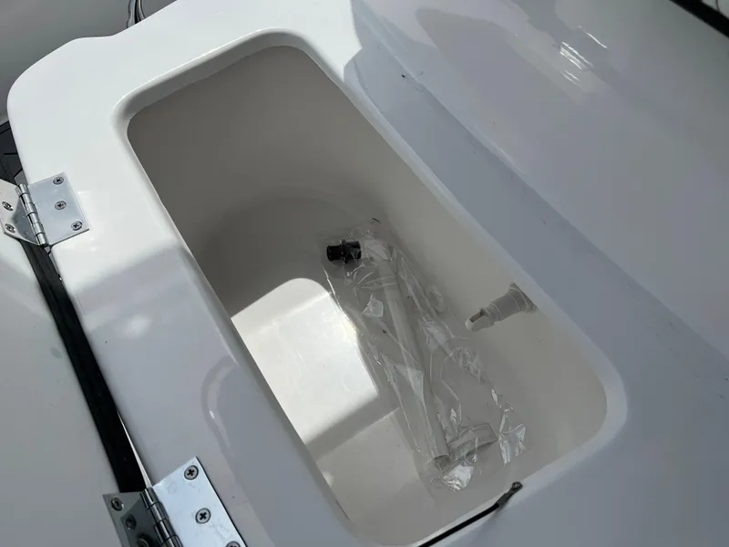 Slide: The Image of 2024 Clearwater 1900 boat storage compartment with accessories. - 17