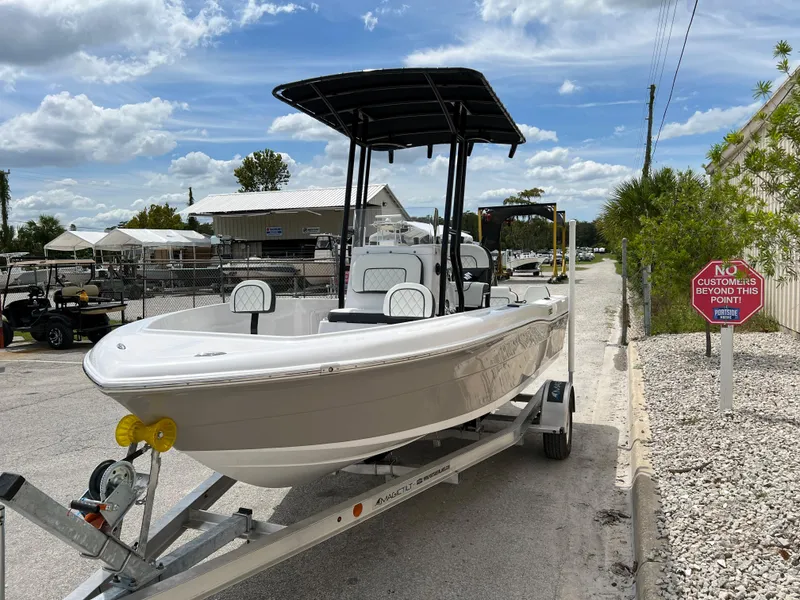 Slide: The Image of 2024 Clearwater 1900 boat on a trailer under a blue sky. - 24