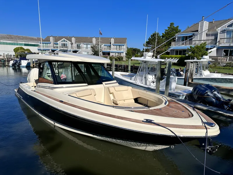 Slide: The Image of 2021 Chris-Craft Calypso 35 boat docked in a marina. - 11
